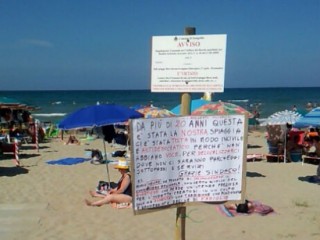 Cartello di protesta in spiaggia