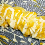 Ravioli all’ortica su vellutata di zucca e crema di grana