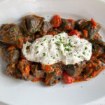 Cappellacci al nero di seppia ripieni di mazzancolle e burrata con sugo di scampi